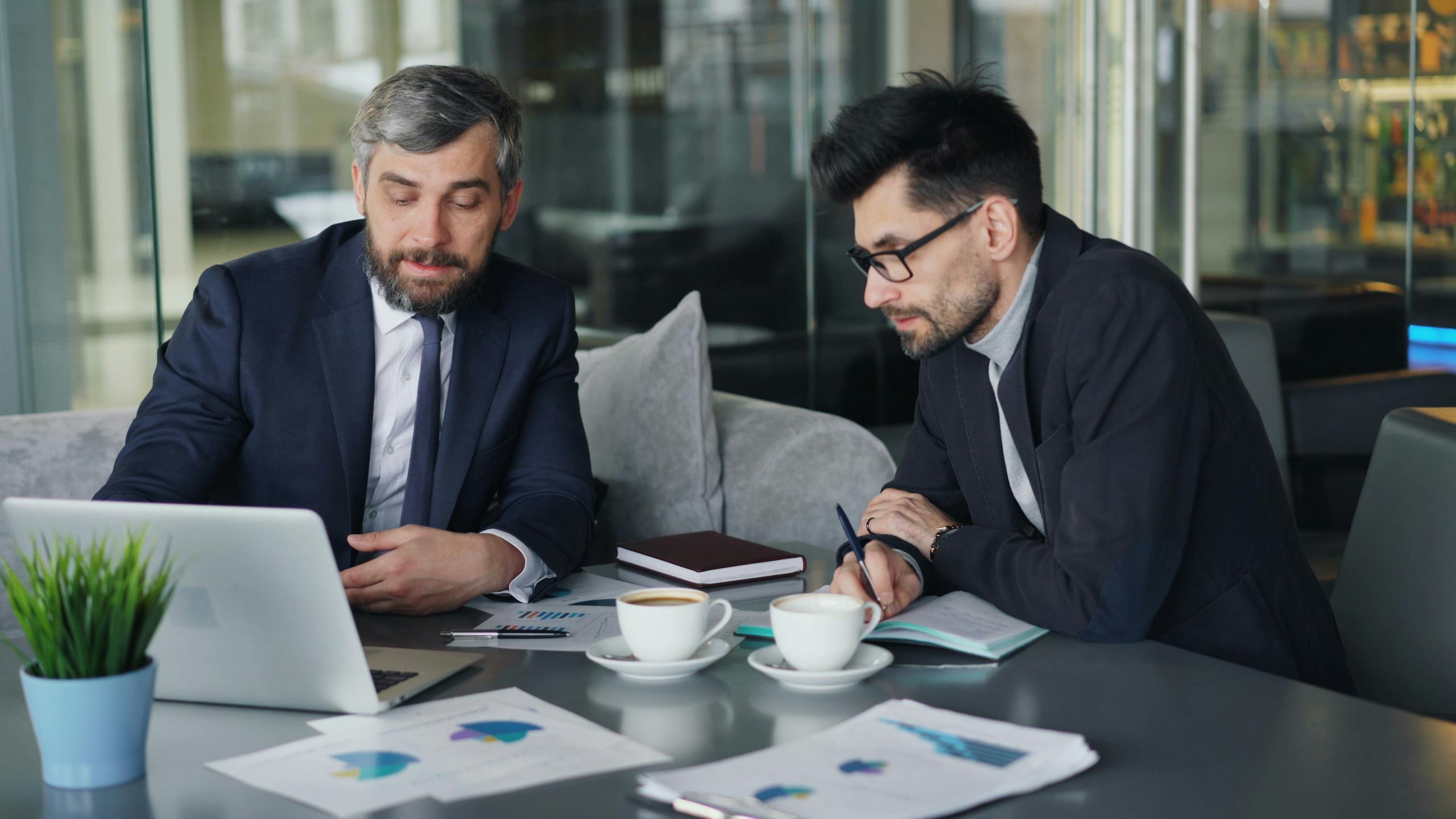 Two professionals planning tax and investments