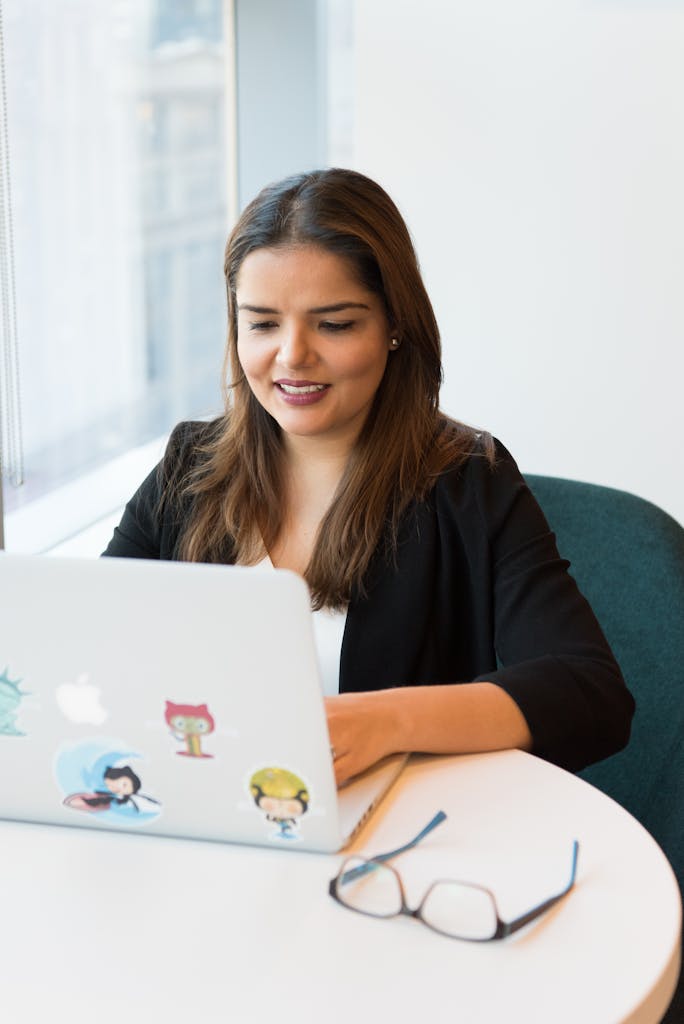 Photography of a Woman Using Laptop doing Management Accounting