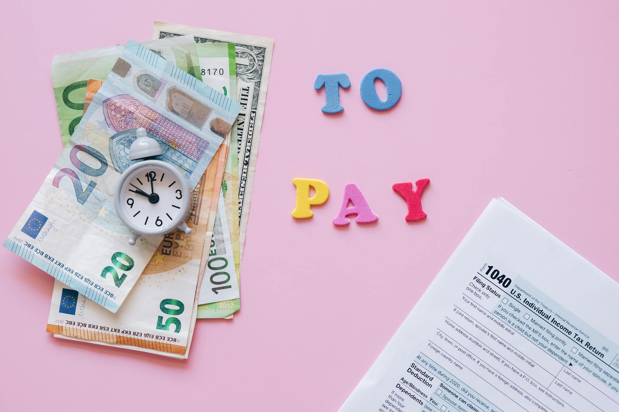 To Pay Sign between Euro Banknotes and Tax Form and Accounting